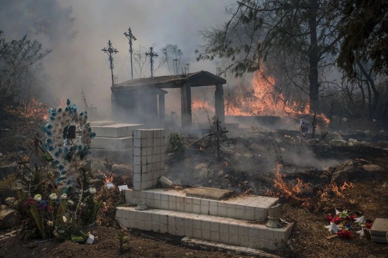 Wildfires burn parts of a cemetery in Nogales, Mexico, Monday, March 25, 2024. (AP Photo/Felix Marquez)