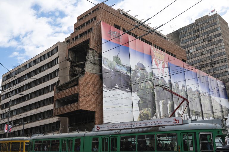 A tram rides past the bomb damaged building of the former federal military headquarters in Belgrade on March 19, 2024, which was destroyed 25 years ago during the US-led NATO air campaign against the former Yugoslavia that ended the Kosovo war. - The former headquarters of the Yugoslav general staff, bombed by NATO 25 years ago, could be reborn in the form of a luxury hotel financed by the Trump family. (Photo by Andrej ISAKOVIC / AFP)