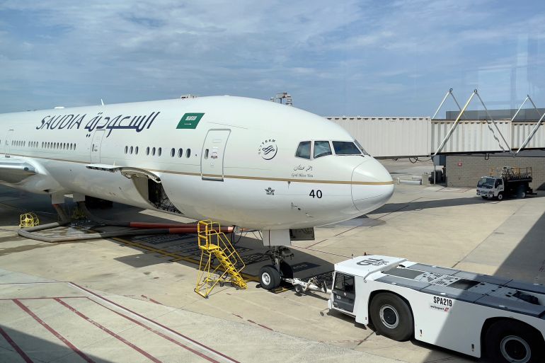A Saudi Airlines plane is seen at gate at Dulles Washington International Airport (IAD), in Dulles, Virginia on August 14, 2021. (Photo by Daniel SLIM / AFP)