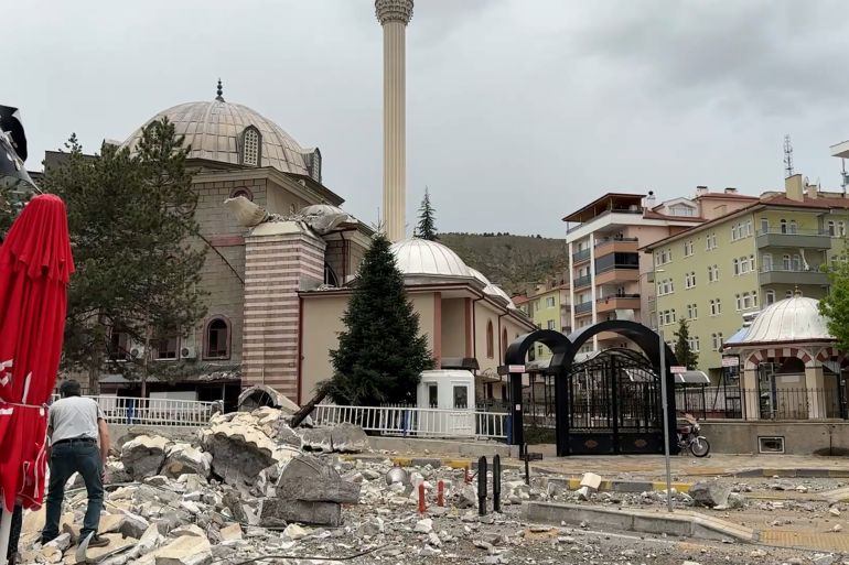 BADEMLIK MOSQUE’S MINARET COLLAPSING DUE TO STORM (TWO SHOTS) 2. VARIOUS OF PEOPLE STANDING AS THEY LOOK AT RUBBLE OF MINARET SPREAD AROUND
