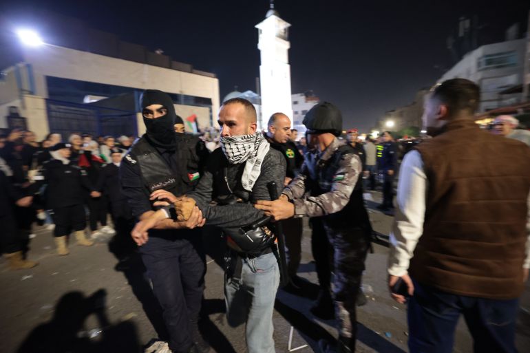 AMMAN, JORDAN, OCTOBER 18: Jordanian riot police clash with angry protesters as tens of thousands arrive at the Israeli embassy on October 18, 2023 in Amman, Jordan. Palestinian officials have said that up to 500 people were killed in an alleged Israeli air strike yesterday at the Ahli Arab Hospital in Gaza City. Israeli officials have suggested that the explosion was caused by a misfired rocket by Palestinian militants. The explosion has sparked strong condemnation, provoking demonstrations in the streets of major cities in the region. (Photo by Jordan Pix/ Getty Images)