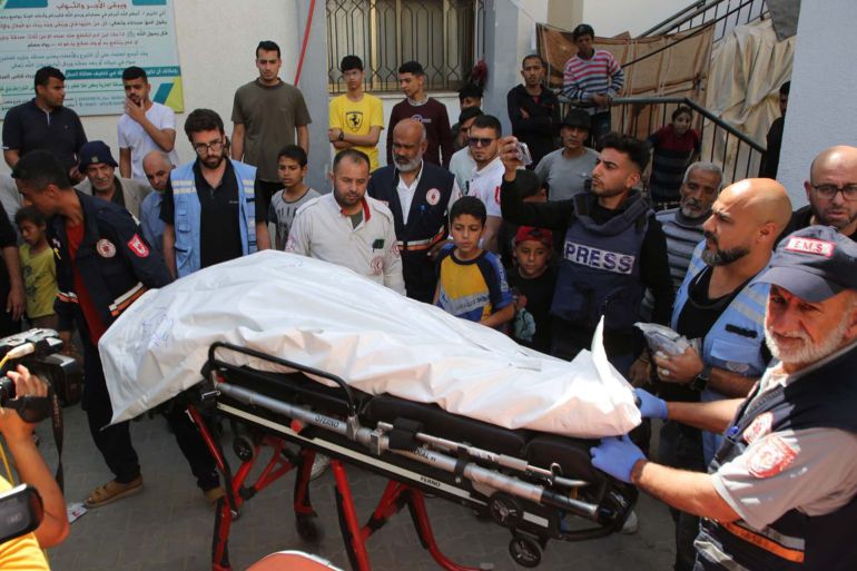 People prepare to transfer the body of a World Central Kitchen WCK worker killed by Israeli air strikes, near the Rafah border crossing, in the southern Gaza Strip, on April 3, 2024. (Khaled Omar / Xinhua via Getty Images)