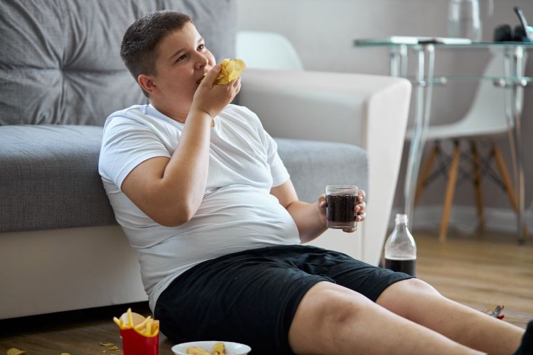 Fat,Overweight,Teenager,Boy,Has,Bad,Nutrition,,Eat,Unhealthy,Food.