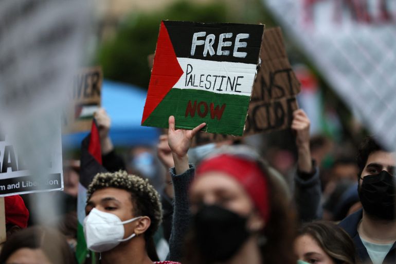 A protester holds a sign as students and others demonstrate at a protest encampment at University Yard in support of Palestinians in Gaza, during the ongoing conflict between Israel and the Palestinian Islamist group Hamas, at George Washington University in Washington, U.S., April 25, 2024. REUTERS/Leah Millis