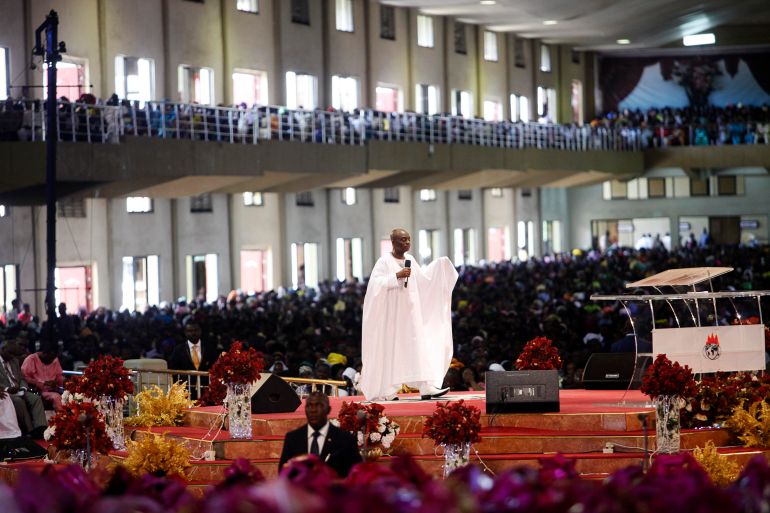 Bishop David Oyedepo (C), founder of the Living Faith Church, also known as the Winners' Chapel, conducts a service for worshippers in the auditorium of the church in Ota district, Ogun state, some 60 km (37 miles) outside Nigeria's commercial capital Lagos September 28, 2014. Hundreds of millions of dollars change hands each year in Nigeria's popular Pentecostal "megachurches", which are modelled on their counterparts in the United States. Some of these churches can hold more than 200,000 worshippers and, with their attendant business empires, they constitute a significant section of the economy, employing tens of thousands of people and raking in tourist dollars, as well as exporting Christianity globally. To match Insight NIGERIA-MEGACHURCHES/ Picture taken September 28, 2014. REUTERS/Akintunde Akinleye (NIGERIA - Tags: RELIGION BUSINESS)